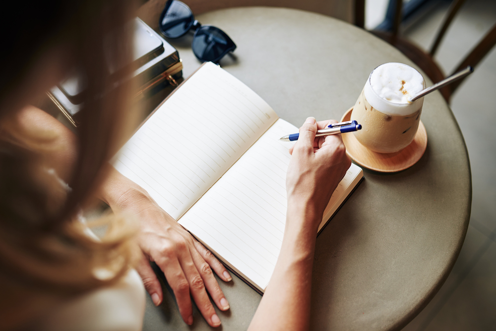 Creative woman filling journal